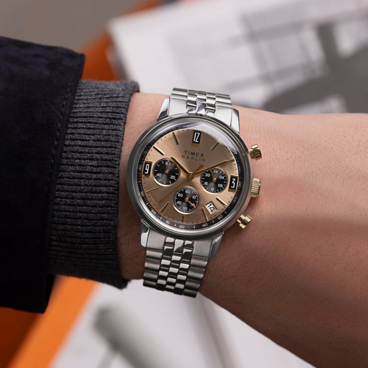 Person wearing TIMEX WATCHES Mod. TW2W60100 with silver and gold tone features on wrist