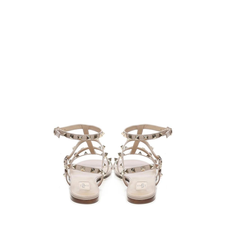 Valentino Garavani Beige Calfskin Sandals with gold-tone rockstuds and ankle buckle fastening, rear view.