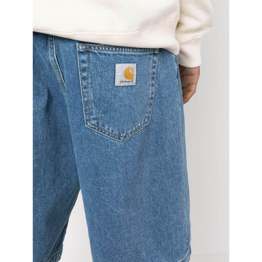 Blue Carhartt WIP MAIN shorts with rear logo patch and knee-length design in washed denim, featuring belt loops and five pockets.