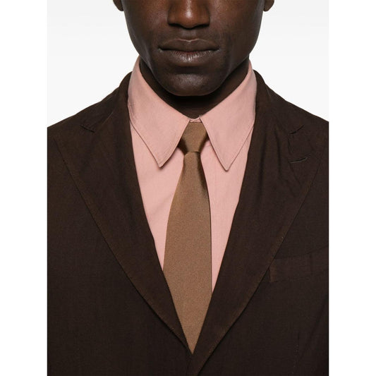 Model wearing a Boglioli brown double-breasted wool suit with pink shirt and beige tie, showcasing front button fastening detail.
