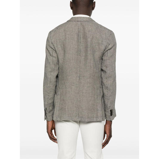 Back view of Boglioli grey linen single-breasted jacket with English vents and patch pockets, worn by model in white pants.