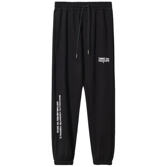 Comme Des Fuckdown black cotton sweatpants with drawstring, logo print on front and sides, featuring side pockets.