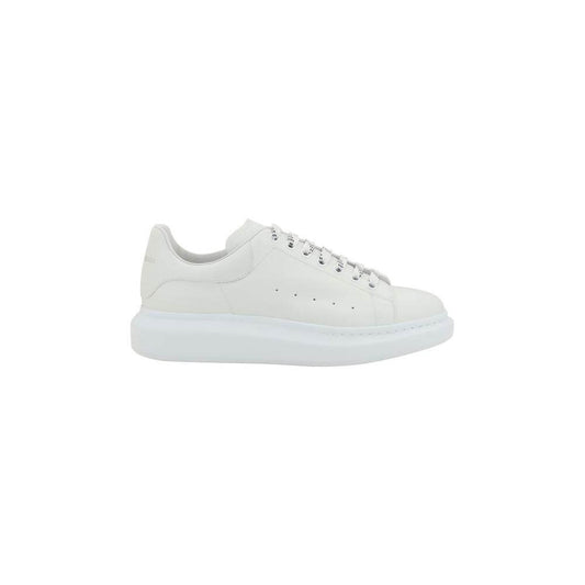 Alexander McQueen leather sneakers with platform sole, lace-up front, logoed heel, and round toe design in white.