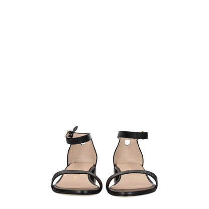 Stuart Weitzman Black Leather Flat Sandals with buckle closure and open toe, mid heels, casual style. MPN: NUDISTJUNESMOS6743BLACK.