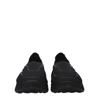 Givenchy Black Fabric Slip-On Loafers with round toe and mid heels, featuring a side logo. Casual style fabric loafers.