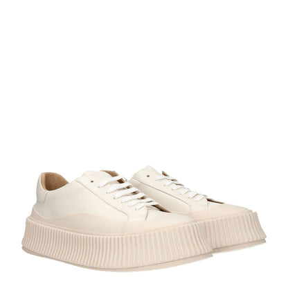 Jil Sander Beige Leather Platform Sneakers with aged effect, lace-up closure, rubber sole, round toe, and wedge heel.