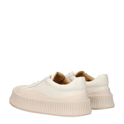 Jil Sander Beige Leather Platform Sneakers with aged effect and wedge heel, featuring lace-up closure and rubber sole.