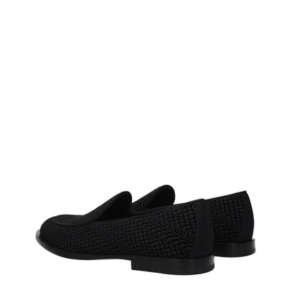 Dolce & Gabbana Black Velvet Slip-On Loafers with logo design, leather sole, and round toe, side view.