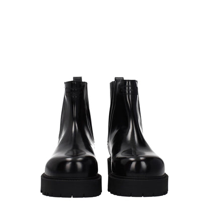 Givenchy Black Leather Ankle Boots with front and back logo, rubber sole, mid heels, and round toe, style for casual outfits.