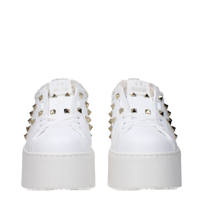 Valentino Garavani White Leather Platform Sneakers with studs, lace-up design, and rubber sole featuring wedge heel for casual style.