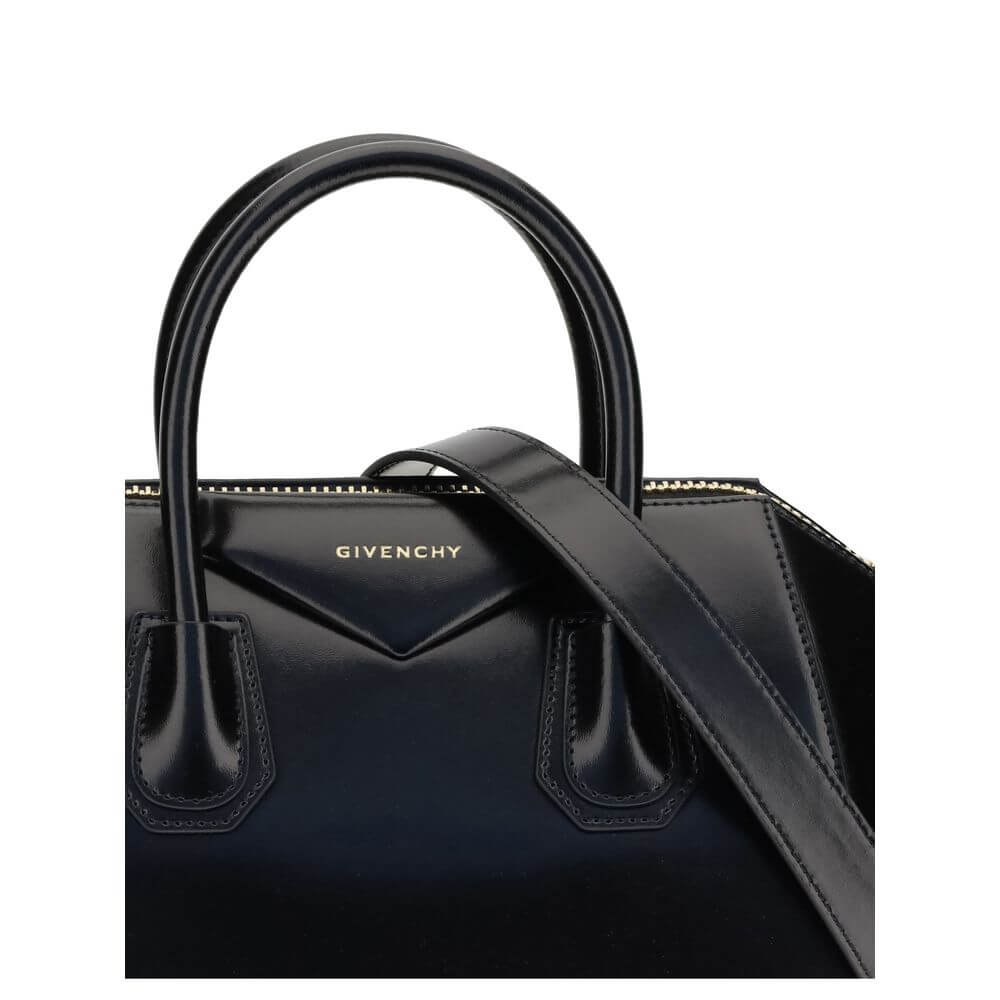 Givenchy Black Calf Leather Bos Taurus Handbag with gold embossed signature and luxurious gold-finish details showcasing elegance.
