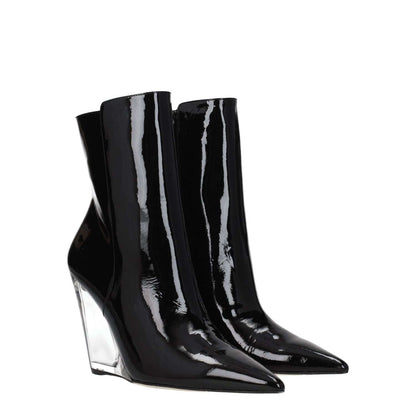 Stuart Weitzman Black Leather Ankle Boots with 10 cm wedge heel, patent finish, and zip closure, featuring a pointy toe and gold accents.