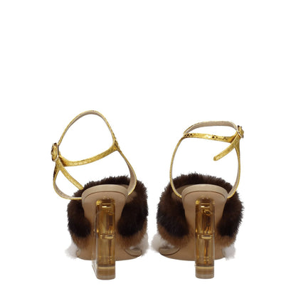 Fendi Brown Mink Strap-On Sandals with gold buckle closure, high heel, and open toe design. Features side logo and vintage effect.
