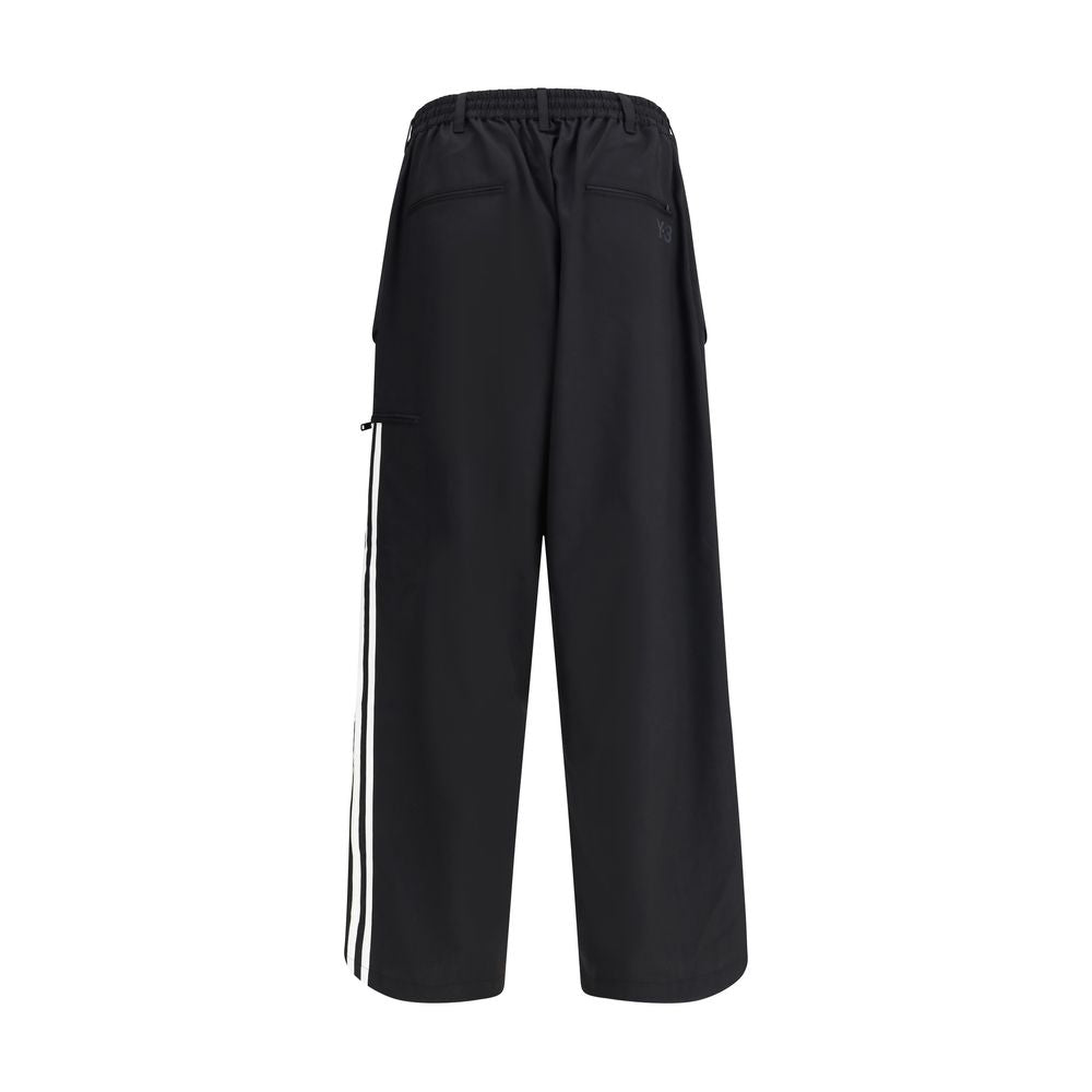 Y-3 Black Wool Casual Pants with elastic waistband and asymmetrical cuffs, featuring side stripes and back pockets.