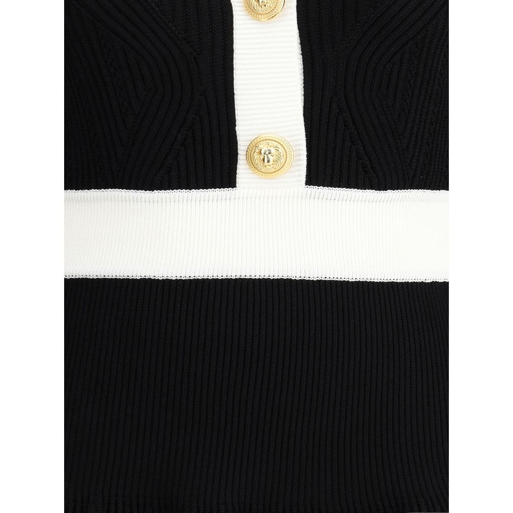 Close-up of Balmain Black Viscose Casual Dress with ribbed knit texture and embossed gold buttons on front closure.