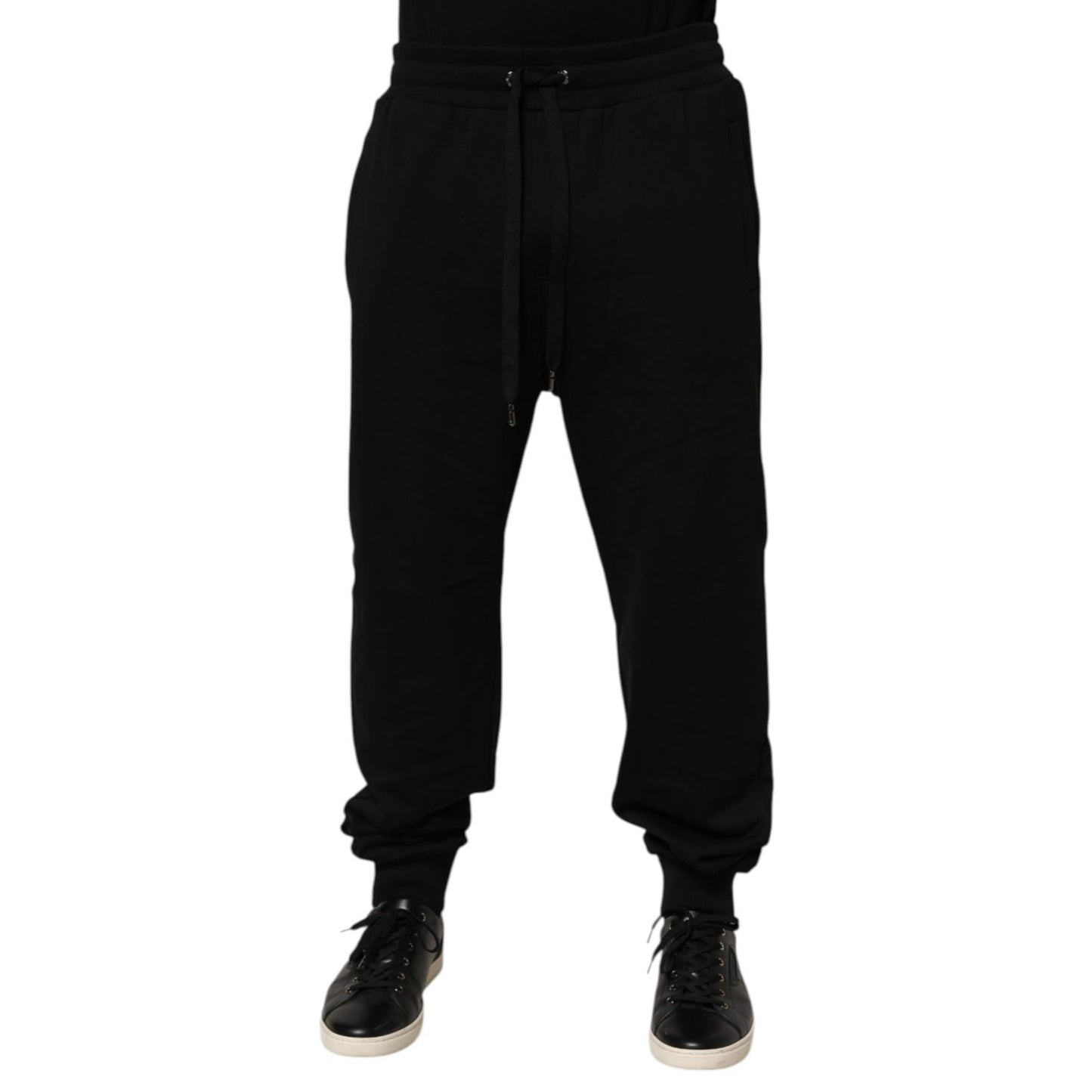 Dolce & Gabbana Black Cotton Drawstring Logo Sweatpants Pants featuring ribbed hems and logo patch on back. Ideal for luxury casualwear.
