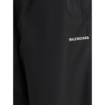 Balenciaga Black Polyester Casual Pants with logo detail, featuring a stylish wide-leg design and elasticized waistband for comfort and style.
