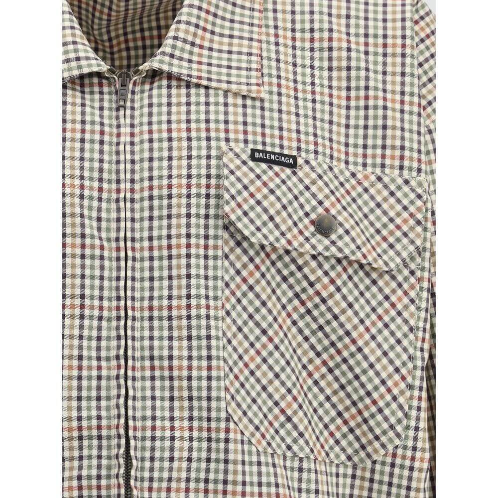 Close-up of Balenciaga Multicolor Cotton Coat featuring checked flannel, chest pocket, zipper, and Balenciaga logo embroidery.