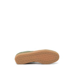 Closed Sneakers Green showing gum-rubber sole with honeycomb texture, olive green leather, contrasting trim, and front lace-up fastening.