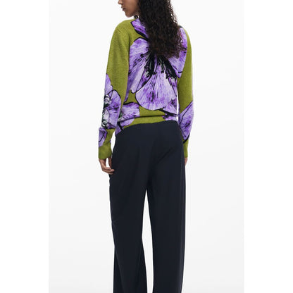 Back view of a model wearing Desigual Purple Elastane Women Sweater featuring bold purple floral patterns, paired with black pants.