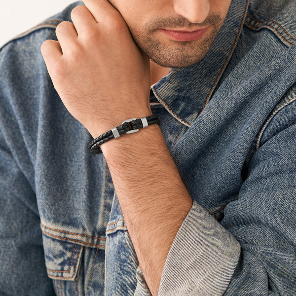 Man wearing FOSSIL JEWELS JEWELRY Mod. JF04202040 bracelet and denim jacket, showcasing stylish accessory look.