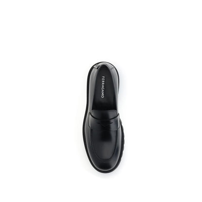 Top view of Ferragamo Black Rubber Slip-On Loafers with rounded toe and brushed calfskin upper, featuring a bold rubber sole.