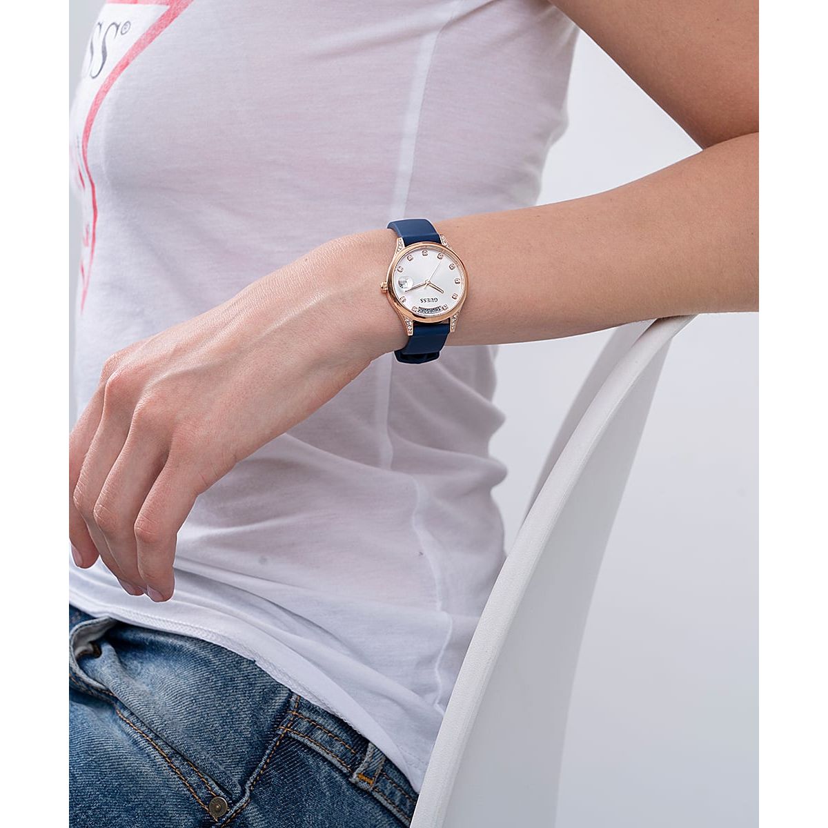 Lady wearing GUESS Mod. GW0356L1 silver earrings with mineral dial quartz analog, 3 ATM water resistant.
