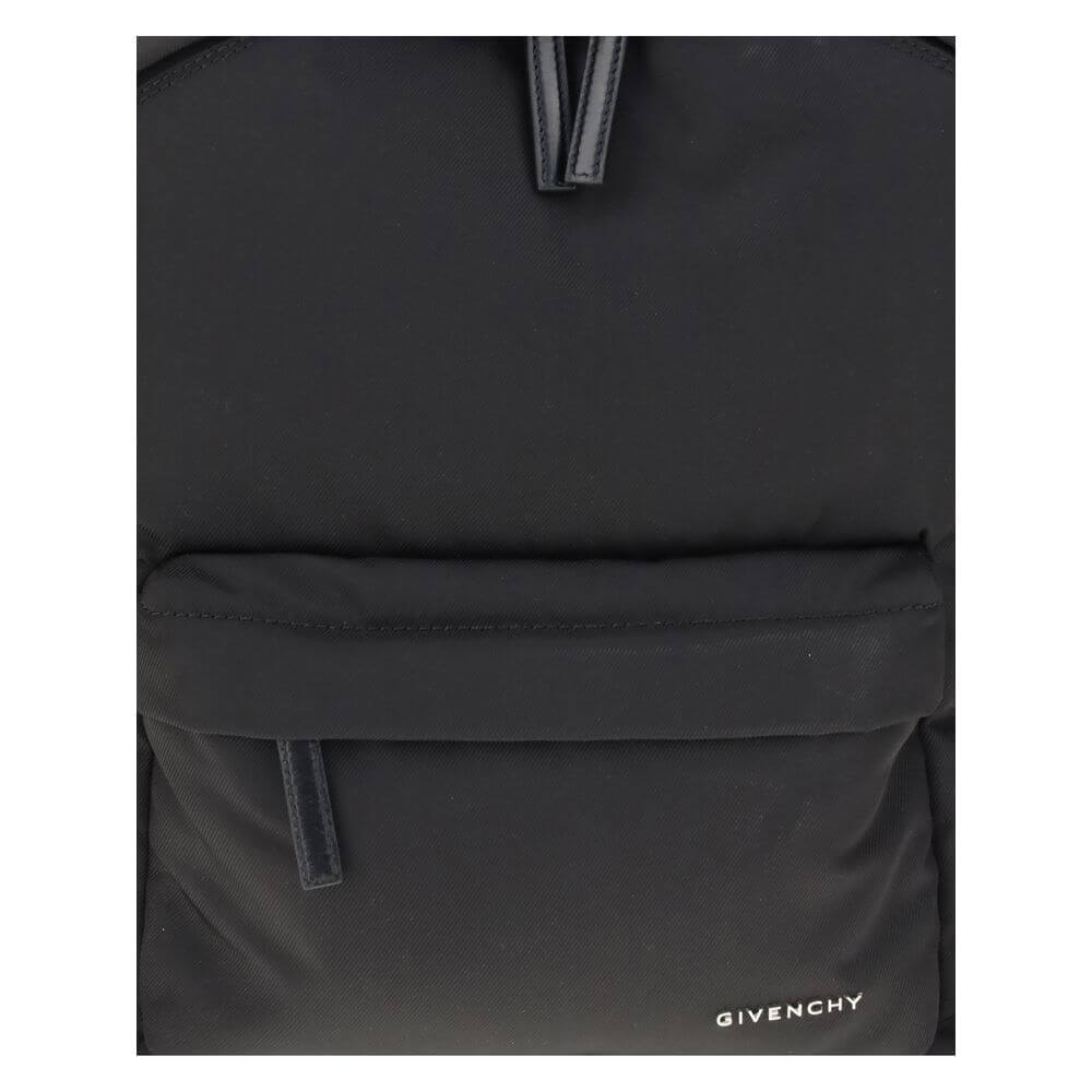 Close-up of Givenchy Black Polyamide Backpack with front metal signature and zippered pockets.