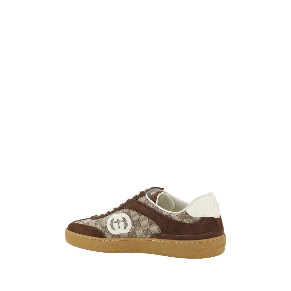 Gucci Brown Calf Leather Bos Taurus Low Top Sneakers with suede details, GG pattern, and logo patch on sides, shown from side view.