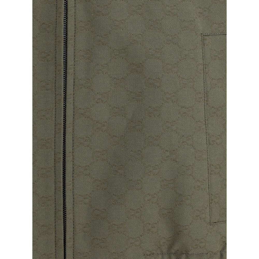 Close-up of Gucci Green Cotton Bomber featuring GG Supreme pattern with a zipper and side welt pocket detail.