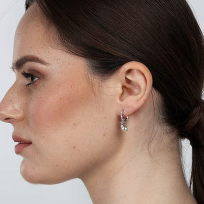 Side view of a woman wearing LA PETITE STORY JEWELRY Mod. LPS02AQM25 earrings with hair tied back, showcasing elegant design.