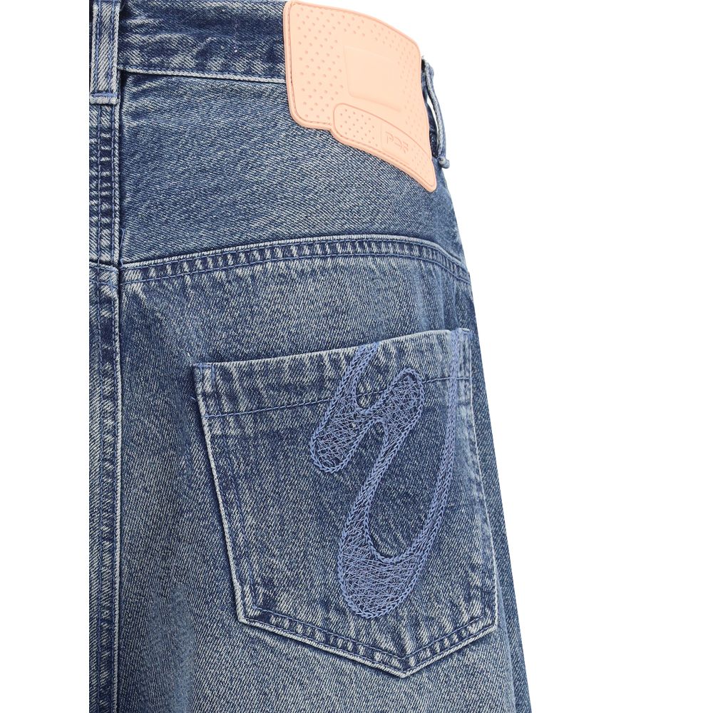 PDF Channel Blue Cotton Relaxed Fit Jeans with urban aesthetic and rubber logo patch on back pocket, AW25 fashion detail.