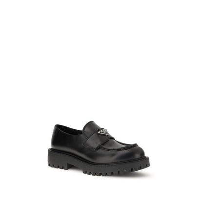 Prada Black Calf Leather Bos Taurus Slip-On Loafers with enameled metal triangle and rubber sole. AW25 collection.