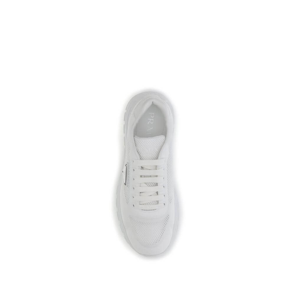 Top view of Prada White Rubber Athletic Sneakers featuring mesh design and enameled logo for urban style.