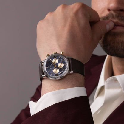 Man wearing TIMEX WATCHES Mod. TW2W60400 on wrist, showcasing stylish design of the watch with a dark brown leather strap.