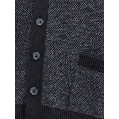 Close-up of Thom Browne Black Fleece Wool Cardigan with buttons and pocket detail, showcasing textured wool fabric and ribbed finish.