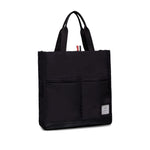 Thom Browne Multi pocket tote bag in black with two top handles, front patch pockets, and internal zip pocket, includes dust bag.