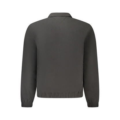 Back view of Tommy Hilfiger Black Polyester Men Jacket with long sleeves and iconic logo detailing.