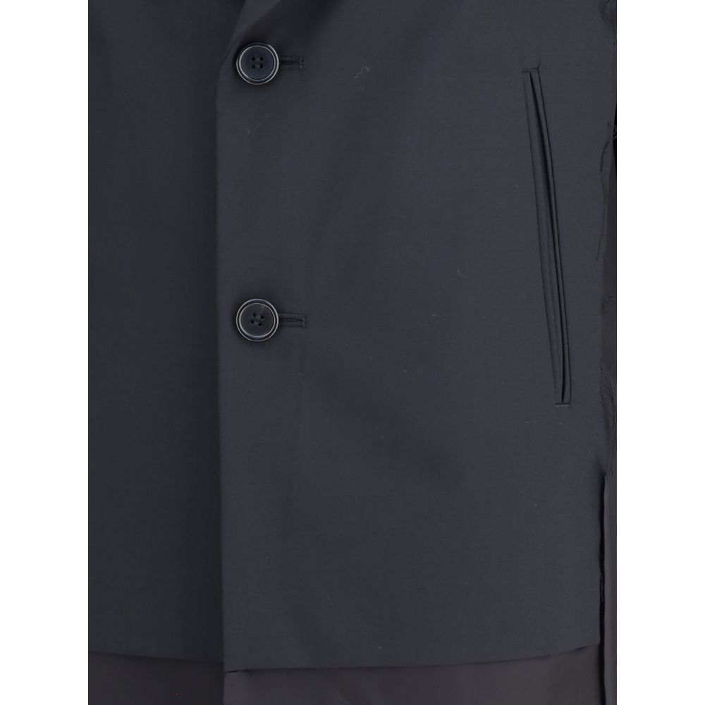 Close-up of Undercover Black Polyester Coat with two-button closure and welt pockets.