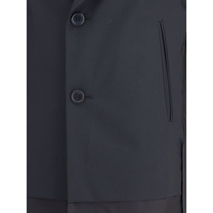 Close-up of Undercover Black Polyester Coat with two-button closure and welt pockets.
