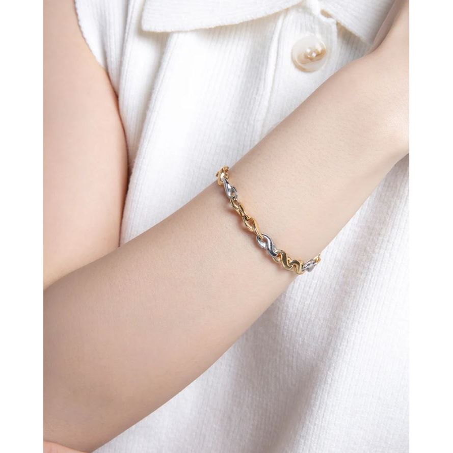 Woman wearing VICEROY FASHION Mod. 14176P01012 silver and gold bracelet, close-up view, elegant jewelry, quartz analog, 5 ATM water resistant.