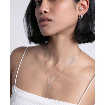 Woman wearing elegant silver 925 earrings and necklace, showcasing stylish modern jewelry design for ladies.