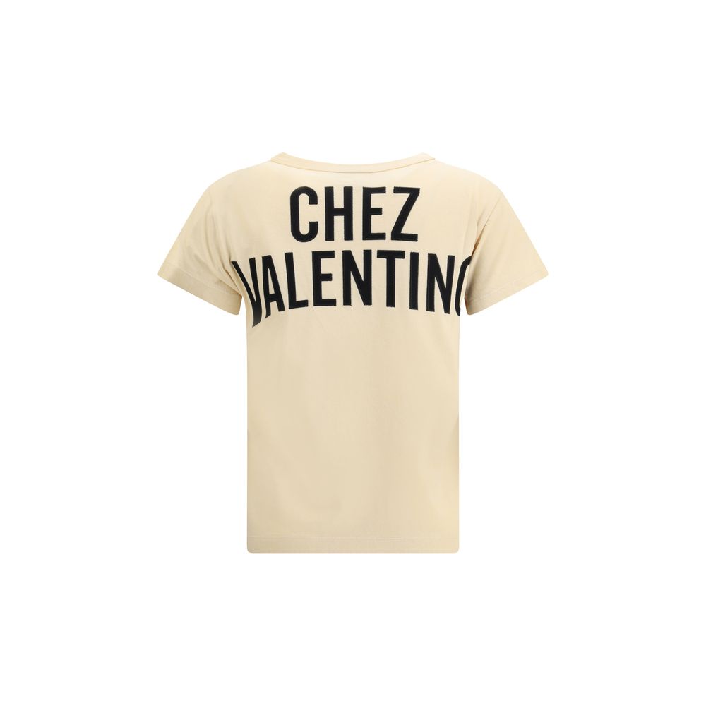 Back view of Valentino Beige Cotton T-Shirt showcasing 'Chez Valentino' text with ribbed crew neck for style and comfort.