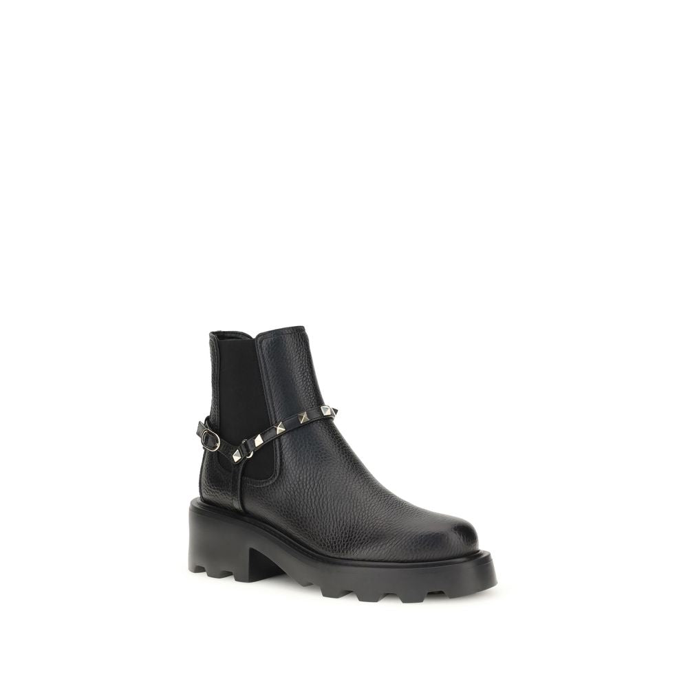 Valentino Garavani Black Calf Leather Bos Taurus Ankle Boots with studded strap and side elastic inserts.