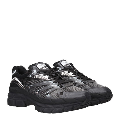 Valentino Garavani Black Fabric Athletic Sneakers with studs, logos, lace-up closure, and rubber soles, featuring mid heels and round toe.