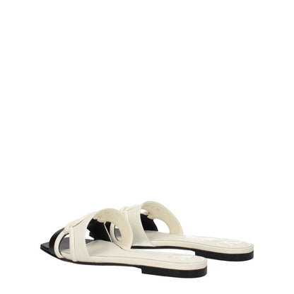 Valentino Garavani Black Leather Slippers with open toe and ivory accents, casual style, low flat heel, leather sole.