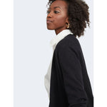 Woman wearing Vila Clothes Black Viscose Cardigan over a white shirt, showcasing a versatile and chic knit style.