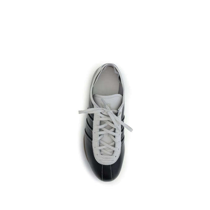 Y-3 Black Calf Leather Bos Taurus Low Top Sneakers with striped detail, top view showing white laces and flat rubber sole.